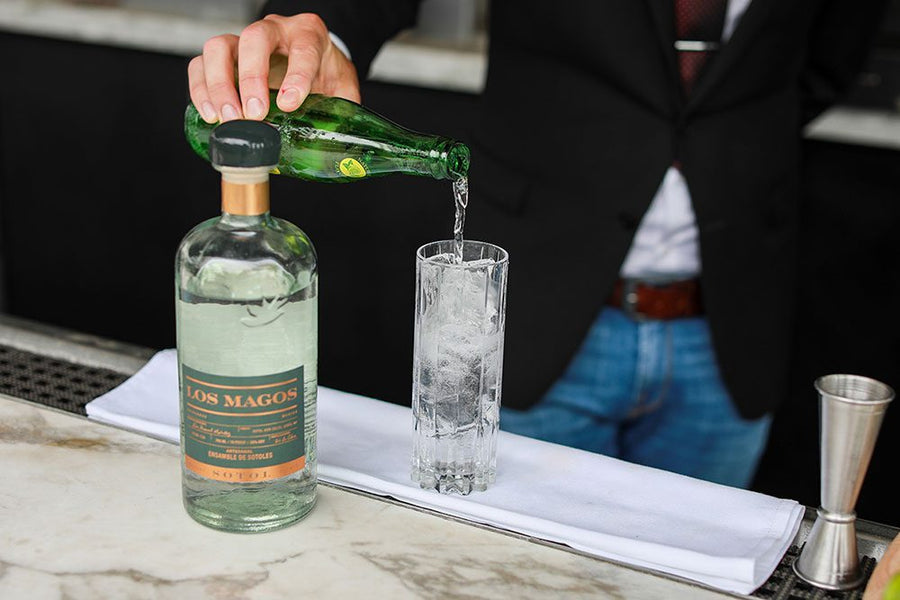 Sotol ranch water in a highball glass with lime