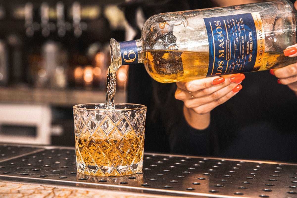 Los Magos 6 Year Reserva being poured into a cut crystal tumbler at a bar