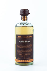 Los Magos WhistlePig Edition #1 sotol, 750ml bottle with wax-dipped cap and 10 Year Rye Whiskey barrel seal, on a white background